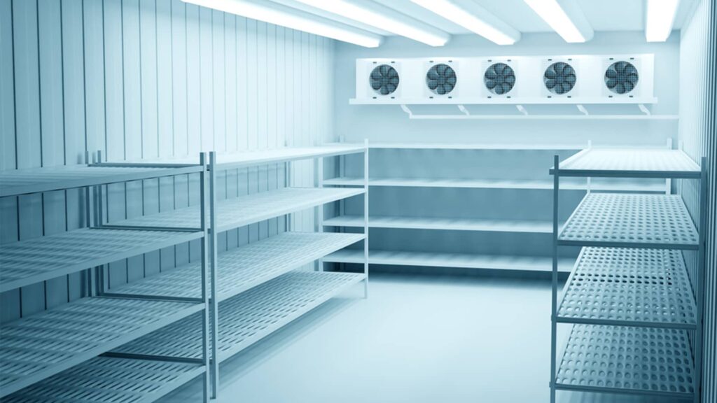 Industrial cold storage racking system with ventilated metal shelves and overhead cooling units for efficient space optimisation in a refrigerated warehouse.